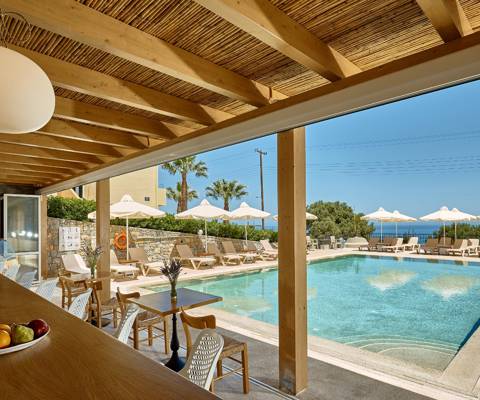 Marni Village outdoor pool bar near the shared pool with umbrellas and sunbeds