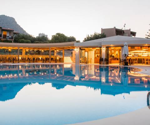 Marni Village main pool near the bar and restaurant during dusk