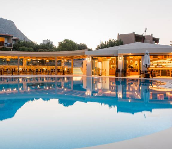 Marni Village main pool near the bar and restaurant during dusk