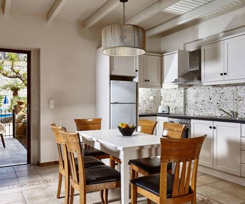 Marni Hotel Villa spacious kitchen with dining table and access to private terrace