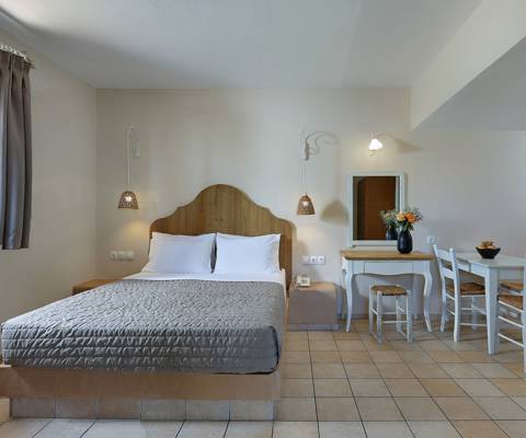 Marni Hotel Superior Studio interior with double bed and dining area