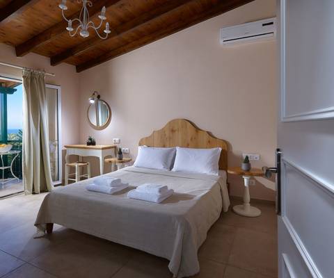 Marni Hotel Superior Family Suite Private Pool bedroom with double bed, wooden ceiling and private balcony