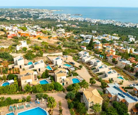 Marni Village aerial view of Hersonissos coastline and hillside villas with the view of the sea