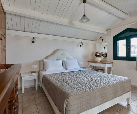 Marni Hotel Maisonette upper floor with double bed, bedside tables, window view and sloped ceiling