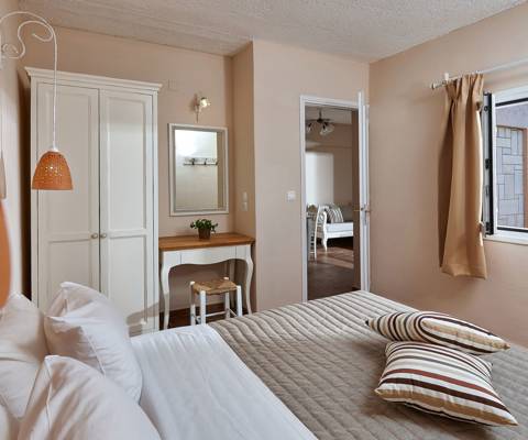 Marni Hotel Premium One Bedroom Apartment interior with double bed, window view and connecting living area