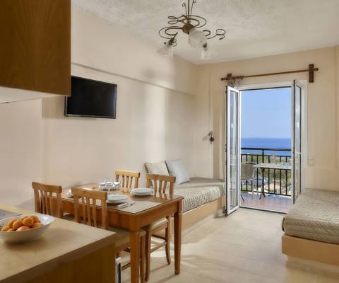 Marni Hotel Premium One Bedroom Apartment with dining table,  TV, sofa beds and sea view balcony