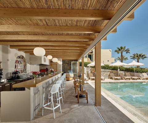 Marni Village outdoor pool bar near the shared pool with umbrellas and sunbeds