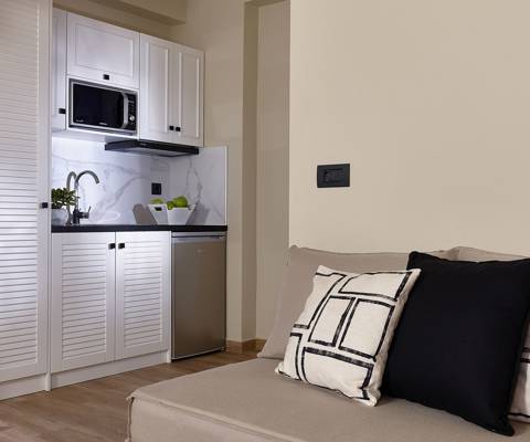 Marni Hotel Deluxe Maisonette Private Pool kitchenette with white cabinets, microwave and compact fridge