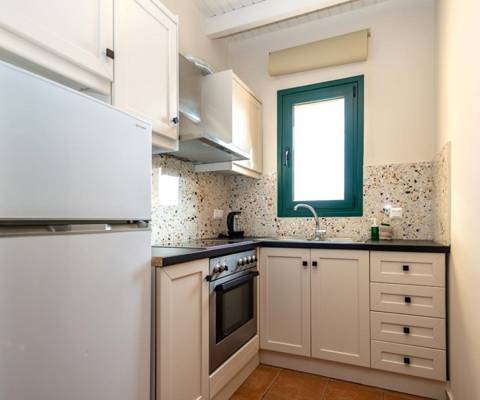 Marni Hotel Suite kitchen with fridge, oven and modern design