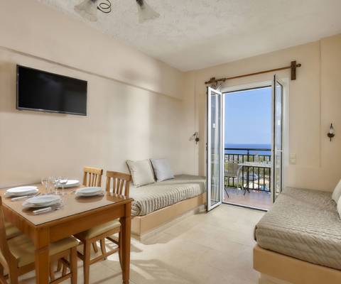Marni Hotel Premium One Bedroom Apartment with dining table,  TV, sofa beds and sea view balcony