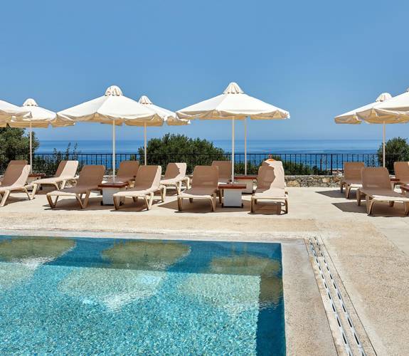 Marni Village shared pool area with umbrellas and sunbeds