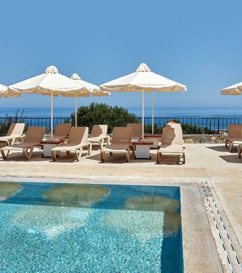 Marni Village shared pool area with umbrellas and sunbeds