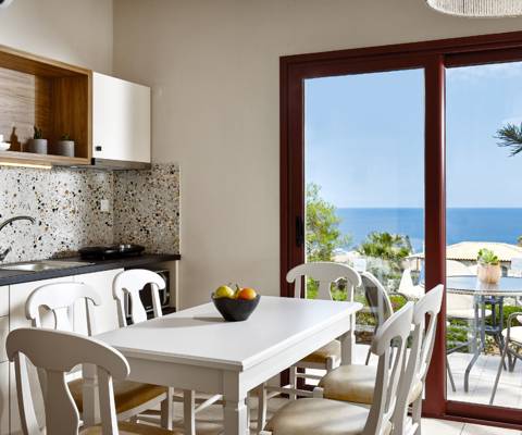 Marni Hotel Superior House Suite kitchen with wooden cabinets, dining table and access to private terrace 