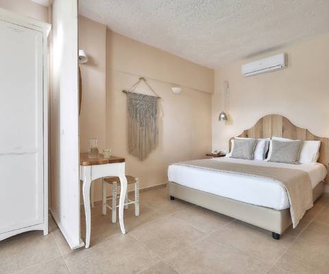 Marni Hotel One Bedroom Apartment Private Pool bedroom with vanity desk, macrame wall decor and wardrobe