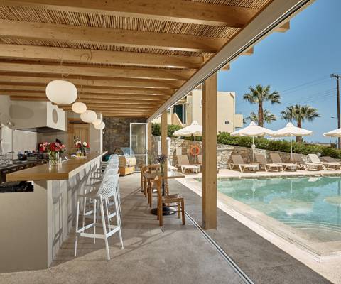 Marni Village outdoor pool bar near the shared pool with umbrellas and sunbeds