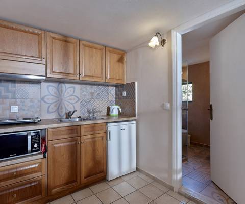 Marni Hotel Maisonette kitchenette with wooden cabinets and patterned backsplash tiles