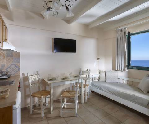 Marni Hotel Junior Apartment dining area with sea view, kitchenette and TV