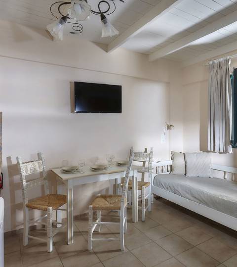 Marni Hotel Junior Apartment dining area with sea view, kitchenette and TV