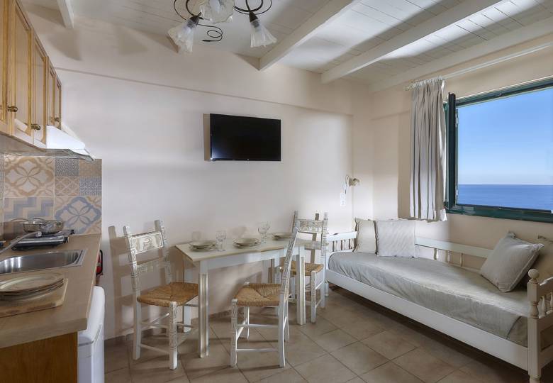 Marni Hotel Junior Apartment dining area with sea view, kitchenette and TV