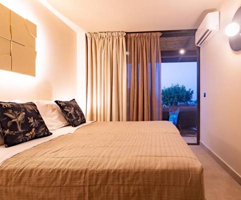 Marni Hotel Luxury Two Bedroom Villa bedroom with double bed, modern lighting and access to terrace