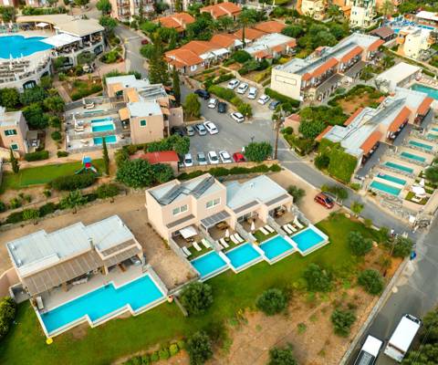 Marni Villas aerial view featuring private pool suites, shared pools and main road access