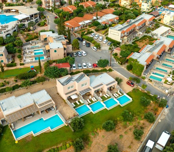 Marni Villas aerial view featuring private pool suites, shared pools and main road access