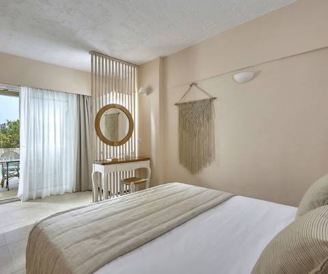Marni Hotel One Bedroom Apartment Private Pool bedroom with vanity desk, macrame wall decor and access to private pool