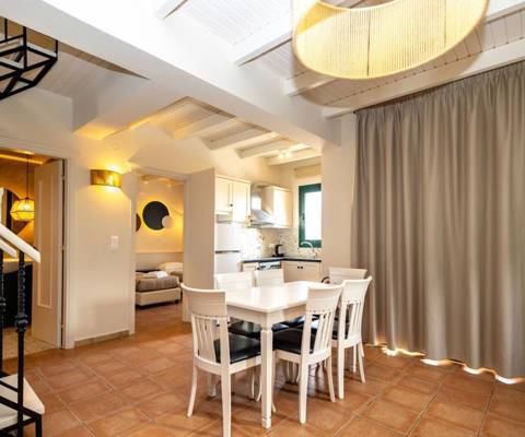 Marni Hotel Villa dining area near the kitchen and a modern staircase