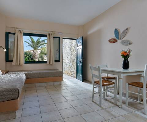 Marni Hotel Superior One Bedroom Apartment with dining table, two sofa beds and open garden view