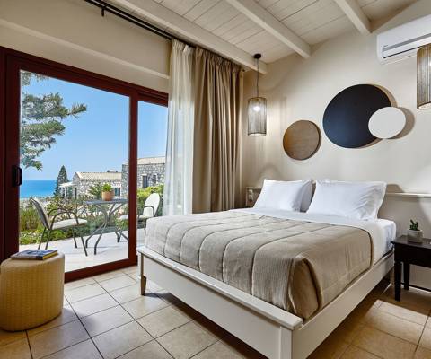 Marni Hotel Superior House Suite bedroom with double bed, bedside tables and access to private terrace