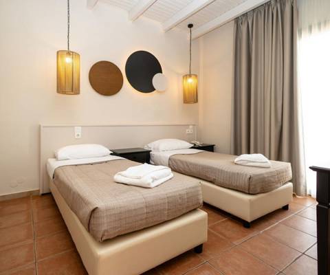 Marni Hotel Villa bedroom with two beds, modern pendant lighting and wardrobe
