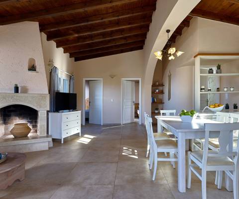 Marni Hotel Superior Family Suite Private Pool living area with fireplace, wooden ceiling and kitchen