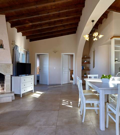 Marni Hotel Superior Family Suite Private Pool living area with fireplace, wooden ceiling and kitchen