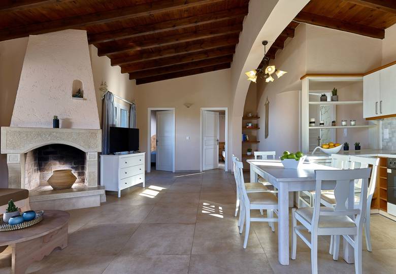 Marni Hotel Superior Family Suite Private Pool living area with fireplace, wooden ceiling and kitchen