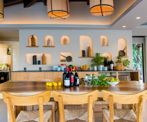 Marni Village wine and fruit display on a wooden counter with decorative wall niches