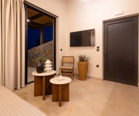 Marni Hotel Luxury Two Bedroom Villa living room with sofa, wall-mounted TV and access to private terrace