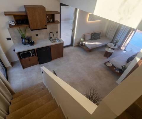 Marni Hotel Luxury One Bedroom Villa view from staircase showing kitchen, living area and access to private terrace