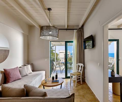 Marni Hotel Superior Suite living area with cornered sofa, coffee table and private balcony