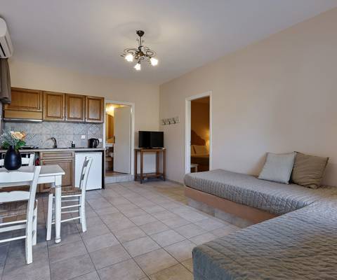 Marni Hotel Superior One Bedroom Apartment living room with sofa-beds, dining table and kitchenette