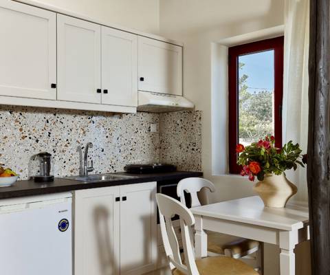 Marni Hotel Junior Suite modern kitchen with dining table and window 