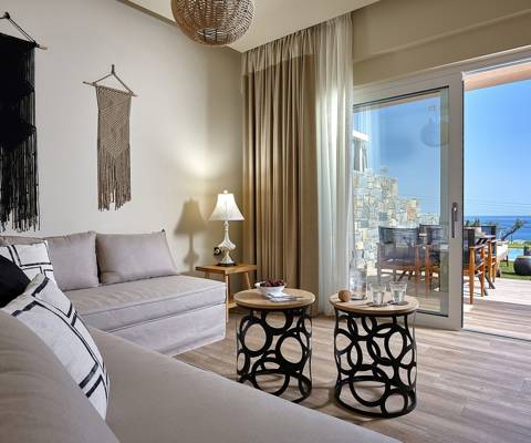 Marni Hotel Deluxe Maisonette Private Pool living area with boho decor, sofas and sea view terrace