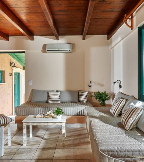 Marni Hotel Superior One Bedroom Apartment living area with built-in sofas and wooden ceiling