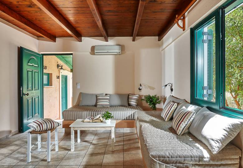 Marni Hotel Superior One Bedroom Apartment living area with built-in sofas and wooden ceiling