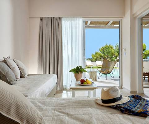 Marni Hotel One Bedroom Apartment Private Pool living area with cornered sofa, coffee table and access to private pool area