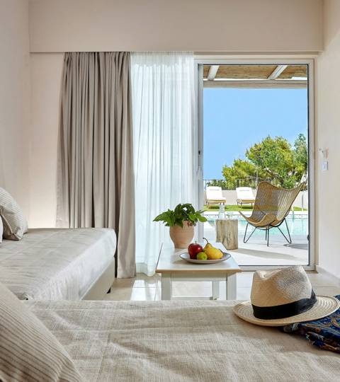 Marni Hotel One Bedroom Apartment Private Pool living area with cornered sofa, coffee table and access to private pool area