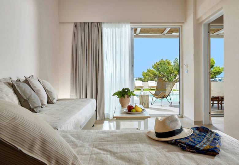 Marni Hotel One Bedroom Apartment Private Pool living area with cornered sofa, coffee table and access to private pool area