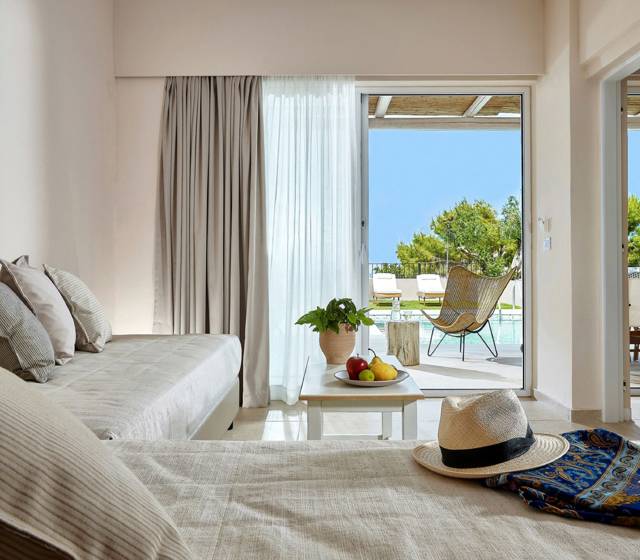 Marni Hotel One Bedroom Apartment Private Pool living area with cornered sofa, coffee table and access to private pool area