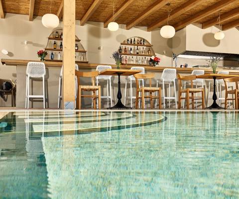 Marni village bar under wooden pergola near the pool