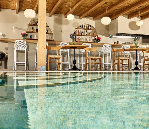 Marni village bar under wooden pergola near the pool