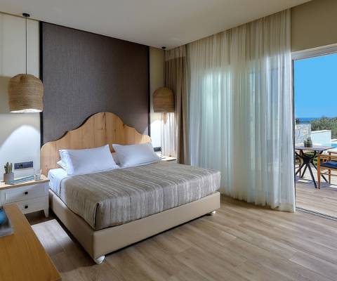 Marni Hotel Deluxe Bungalow Private Pool bedroom with double bed, sea view and access to the pool area